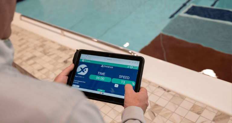 Tablet interface controlling the SwimEx 1000 T, with pool in background.